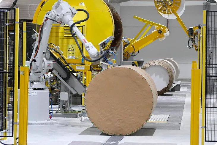 Automated yellow robot handling a paper roll